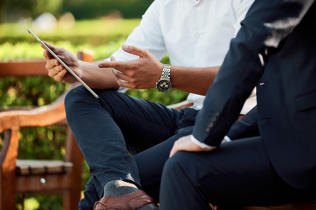 Two businessmen use iot device
