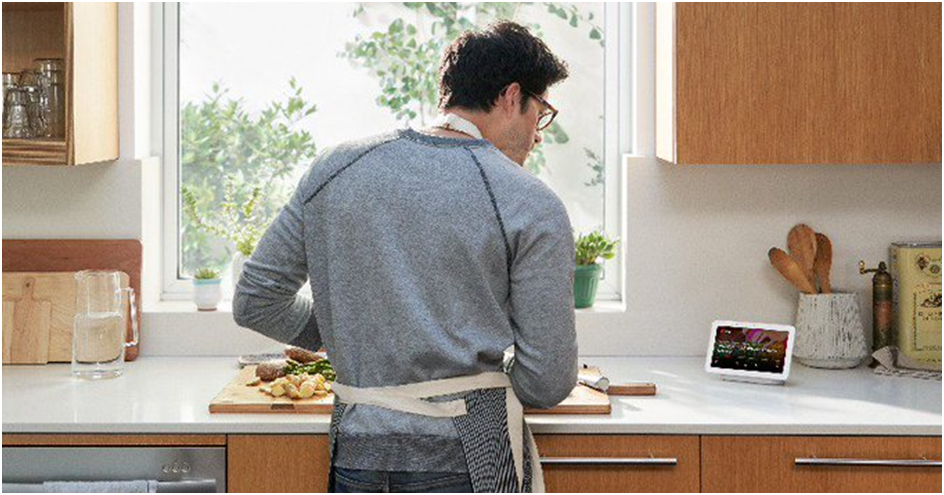 Man is cooking and watching on tablet