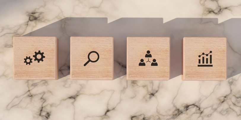 Conceptual business illustration with wooden blocks and icons on marble background